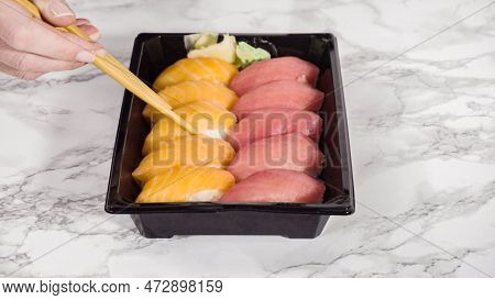 Pre-packaged Variety Of Sushi And Sushi Rolls In A Plastic Tray.