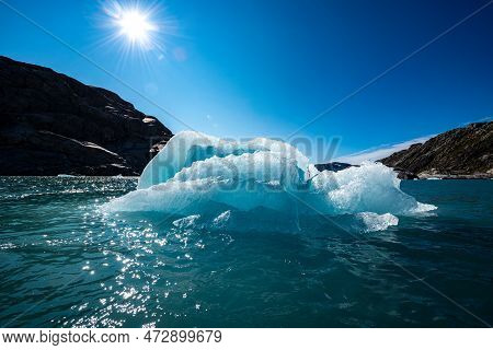 Chunk Of Glacier Ice Lit By Rising Sun Folgefonna Glacier Mosevatnet Lake, Norway