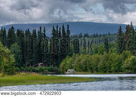 Fairbanks, Alaska, Usa - July 27, 2011: Chena River Wide Landscape With Green Forest, Mountain In Ba