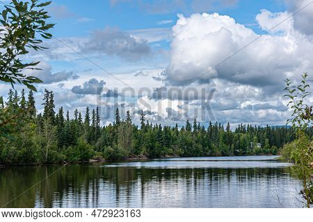 Fairbanks, Alaska, Usa - July 27, 2011: Blue Cloudscape Over Chena River Landscape With Green Forest