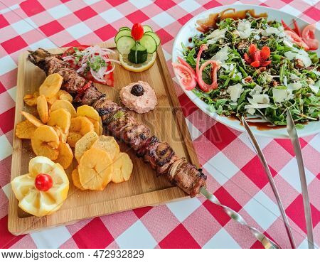 Greek Kontosouvli Large Souvlaki Made By Fresh Meat Grilled On Fire And Served With French Fries.