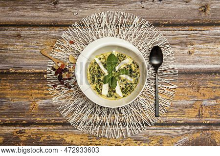 Top View Of Delicious Palak Paneer With Spinach And Good Herb With Black Cuchara And Wooden Teaspoon