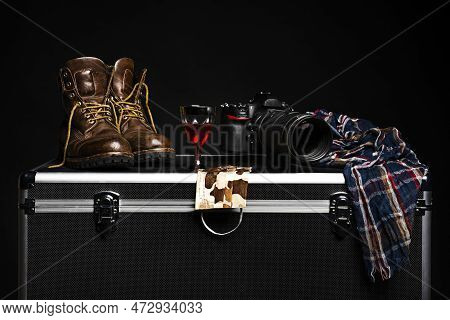 Professional Accessory Box With Mimetic Mask, Camera, Brown Hiking Boots, Scarf And A Glass Of Good 