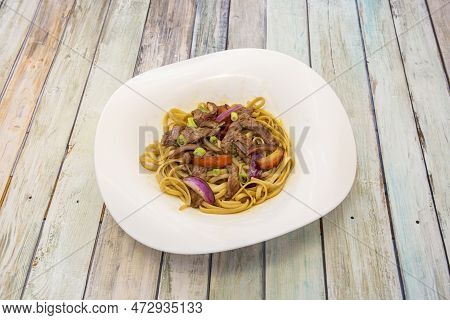 Peruvian-style Sautéed Noodles With Striploin Meat, Fresh Vegetables And Red Onion With Soy Sauce