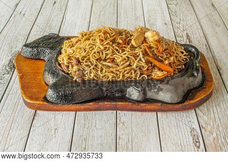 Chinese Restaurant Specialty Noodles Sauteed With Shrimp, Beef And Chicken Meat, Vegetables And Carr