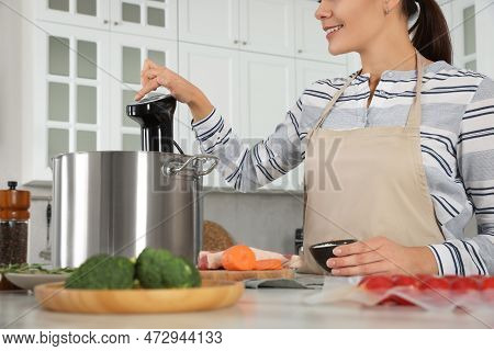 Woman Using Thermal Immersion Circulator In Kitchen, Closeup. Sous Vide Cooking