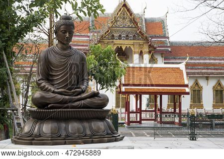 Bangkok, Thailand- 13 Feb, 2023: Buddha Statue Sits Under The Tree In Mable Temple In Bangkok. Mable