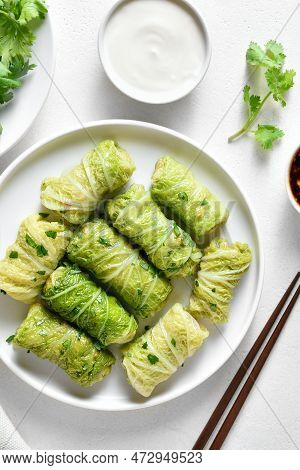 Chinese Style Stuffed Cabbage Rolls Over White Stone Background. Top View, Flat Lay