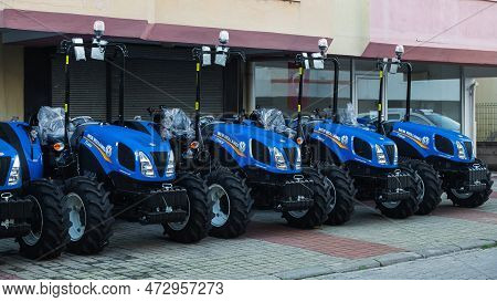 Side , Turkey -  January  27, 2023:    Close-up New Blue Tractors New Holand  Are On Sale In A Car D