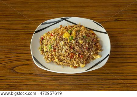 Popular Peruvian Dish Of Chaufa Rice With Egg Omelet, Sautéed Vegetables And Pieces Of Wok Fried Chi