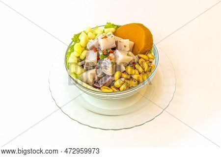 Glass Bowl Filled With Peruvian Fish Ceviche With Cancha, Sweet Potato And Lettuce On White Backgrou