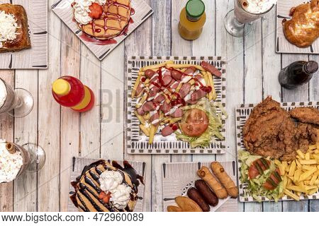 Set Of Fast Food Dishes With A Tray Of Salchipapas, Pancakes With Strawberry And Chocolate Syrup, Wh