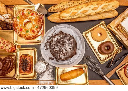 Set Of Sweet Dishes With A Chocolate Cake, A Roscon With Cream, Chocolate Palm Trees, Donuts Of Vari