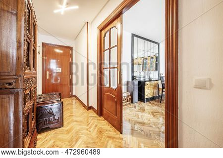 Hallway Of A House With Varnished French Oak Hardwood Floors And Sapele Wood Room Doors With Beveled