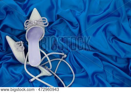 High Heel Shoes  On A Blue Background