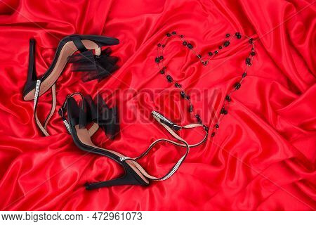 High Heel Shoes  On A Red Background