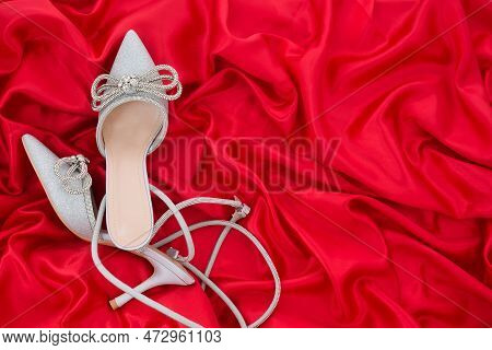 High Heel Shoes  On A Red Background
