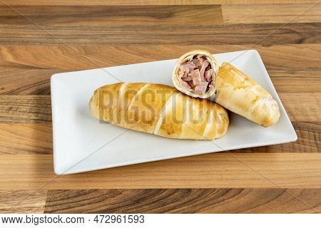 Venezuelan Cachito Stuffed With Sliced Ham And Fresh Cheese For Breakfast