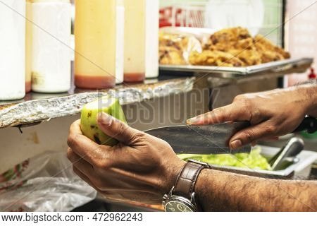A Latino Chef Preparing A Platano Macho To Fry