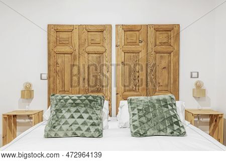 Bedroom With Double Bed With Rustic Headboard With Unvarnished Wooden Shutters And Fruit Boxes As Be