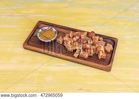 Typical Spanish Tapa Of Torreznos De Soria Fried In Olive Oil With A Bowl Of Dipping Sauce On A Wood