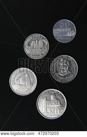 Paraguay Guaranies Coin - Set Of Paraguayan Coins In A Row Isolated On Black Background