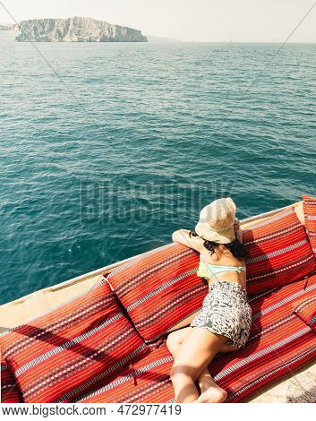 Caucasian Woman Tourist Relax Lay On Vacation On Cruise Ship Deck Enjoy Sunny Persian Gulf Panorama 