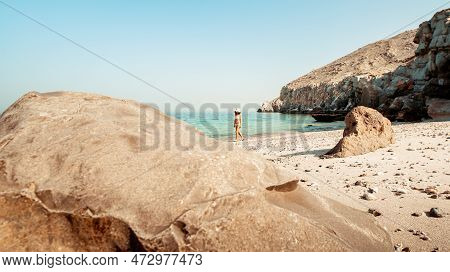 Aerial View Tourist Woman In Bikini Walk On White Sand Beach Alone In Persian Gulf Mirellas Island. 
