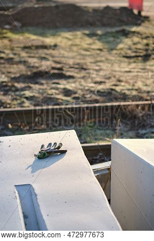 Concrete Blocks Prepared For Building A Railway Crossing Placed On The Ground Near Railroad Tracks, 