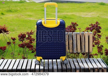Suitcase Near Hotel, Hostel House. Blue Yellow Travel Suitcase For Vacation Holidays Weekends Travel