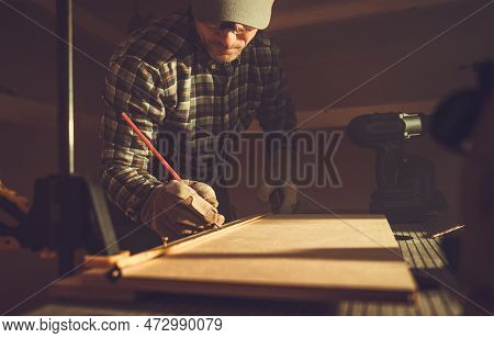 Caucasian Woodwork Artisan And His Small Wood Project Inside A Shed Workplace.