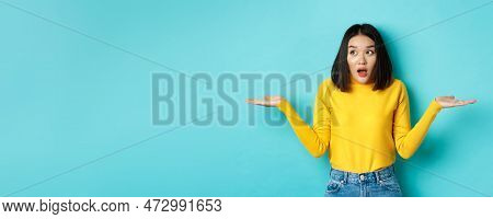 Confused And Shocked Asian Woman Dont Understand, Shrugging With Spread Hands, Gasping And Looking L