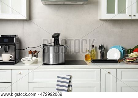 Pot With Sous Vide Cooker In Kitchen. Thermal Immersion Circulator