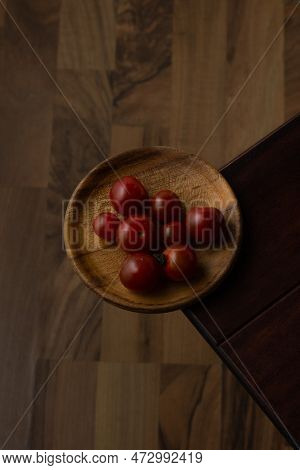 Solanum Lycopersicum Var. Cerasiforme - Cherry Tomatoes On Plate And Wood Background