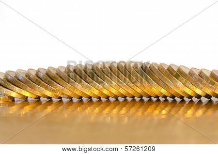 A Number Of Coins Lying On The Golden Surface
