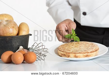 Chef Decorating A Potato Omelette