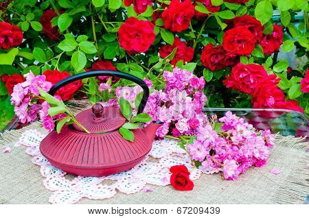 still life bouquet with roses and tea pot