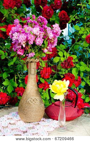 still life bouquet with roses and tea pot