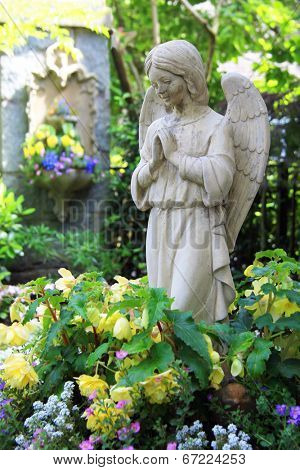 Statue of a praying angel in the garden. 