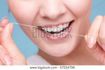 Girl Cleaning Teeth With Dental Floss. Health Care