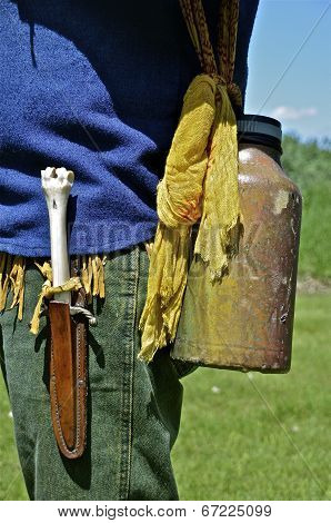 Camper wearing canteen and bone handle knife