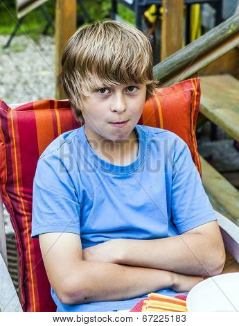 Boy Eating Outside At A Table