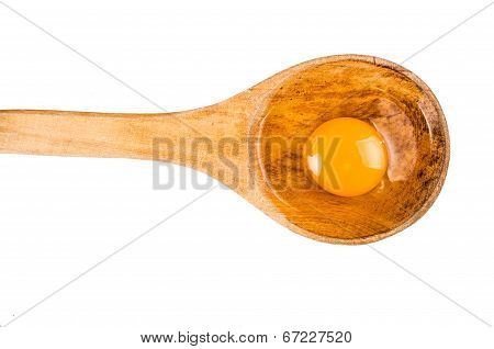 open egg on wooden spoon isolated