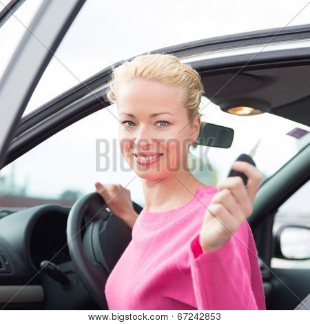 Woman driver showing car keys.
