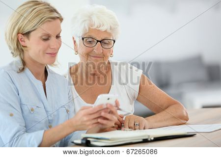 Homehelp booking medical appointment for elderly woman