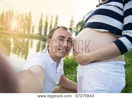 Pregnant couple taking selfie