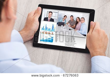 Businessman Video Conferencing With Team On Digital Tablet
