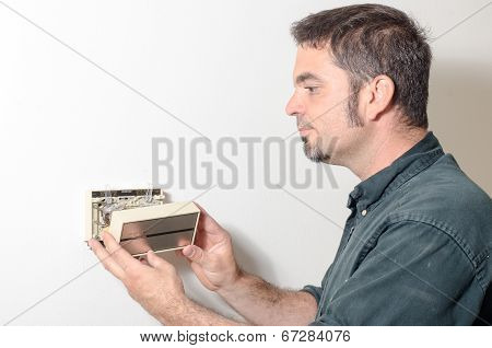 Technician Removing Thermostat Cover