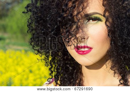 young beautiful girl in the field with bright makeup