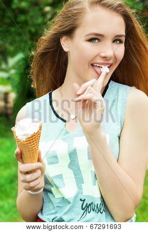 young beautiful happy girl with long hair in a Sunny day walking around the city and eat ice cream